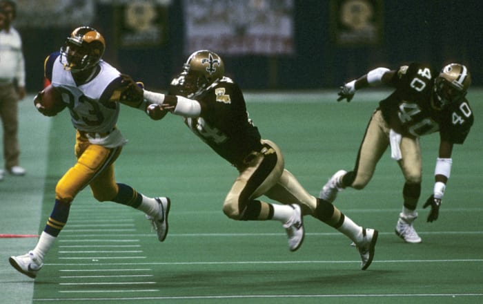 Flipper Anderson makes a catch before going out of bounds against Saints defenders Dave Waymer and Robert Massey